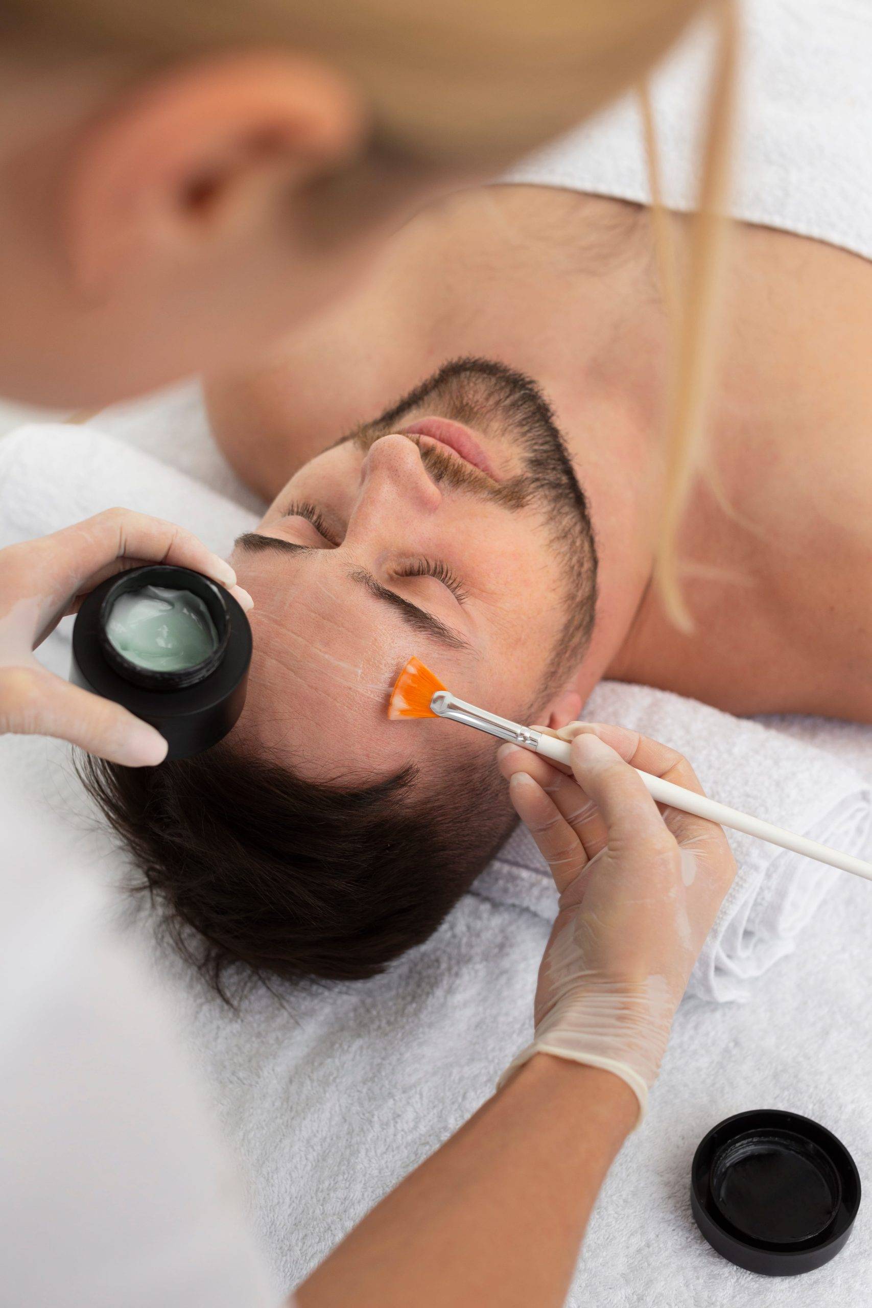 A man having facial treatment in salon